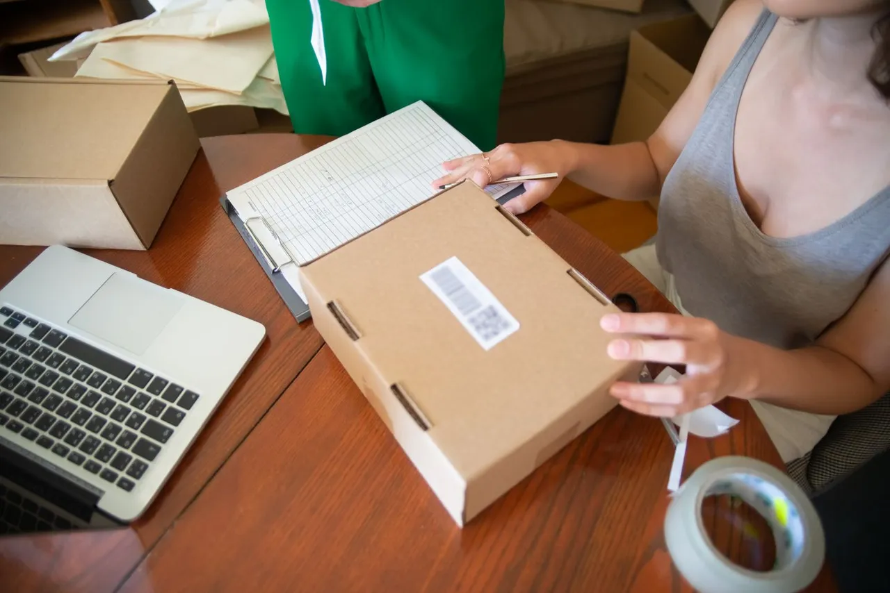 An online order being prepared beside a laptop.